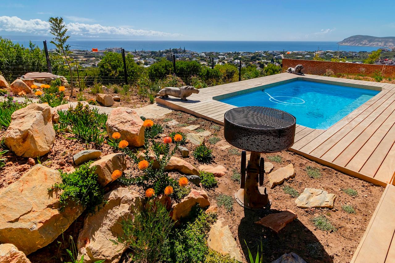 Pool area with decorative fire pit and native landscaping