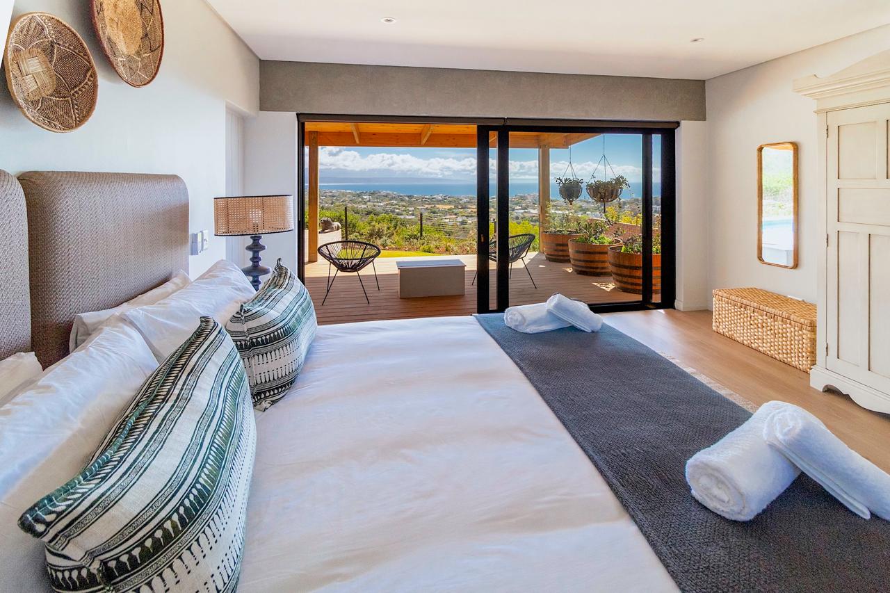 Master bedroom with wicker headboard and private deck overlooking the ocean